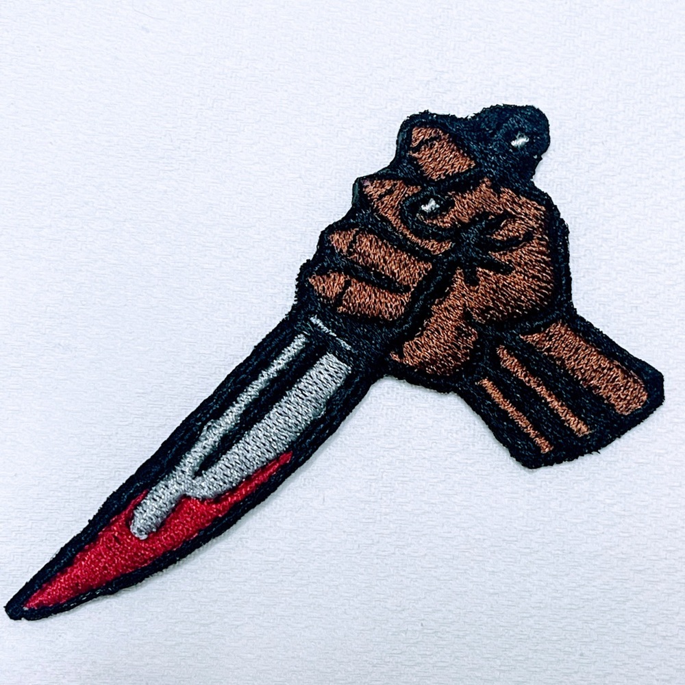 A man with a bloody knife iron on patch